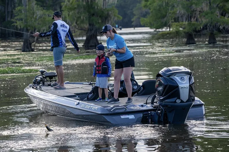 Slide: The Image of Manufacturer Provided Image: Family fishing on a 2025 Skeeter ZXR19 boat in a scenic lake. - 19