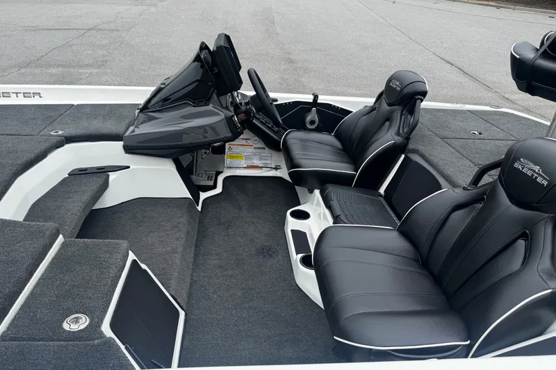 Slide: The Image of 2025 Skeeter ZXR19 boat interior with black leather seats and modern dashboard. - 12