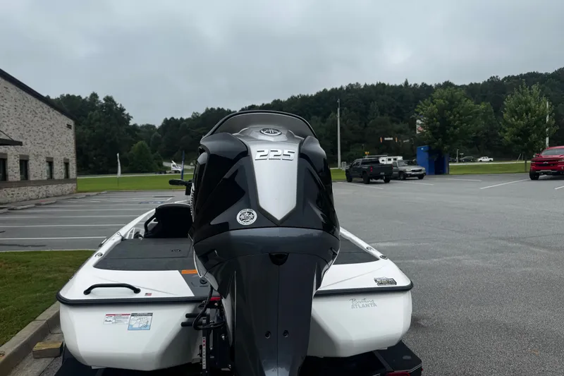 Slide: The Image of 2025 Skeeter ZXR19 boat with powerful 225 engine in a parking lot. - 15