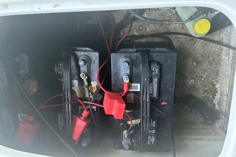 Slide: The Image of Battery compartment of a 2015 Tahoe 215xi I/O boat with visible wiring connections. - 13