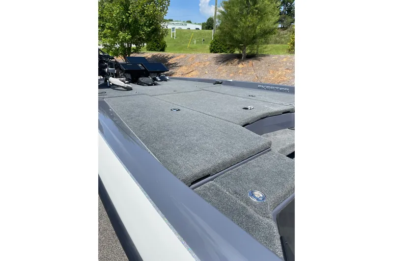 Slide: The Image of 2024 Skeeter ZXR20 boat deck with carpeted surface and storage compartments. - 12