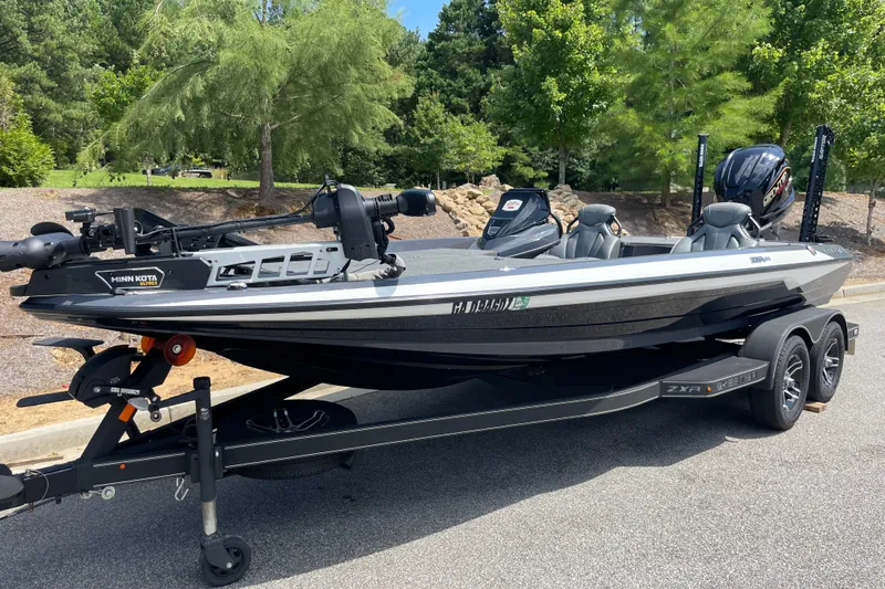 Slide: The Image of 2024 Skeeter ZXR20 boat with Minn Kota motor on trailer, parked outdoors. - 1