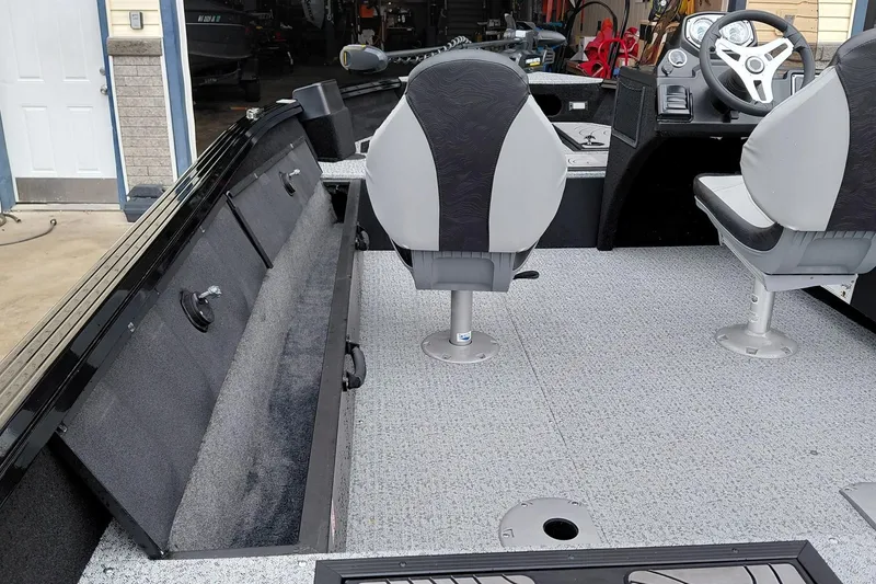 Slide: The Image of 2026 Smoker Craft Excursion 166 SC interior with seating and storage compartments. - 14