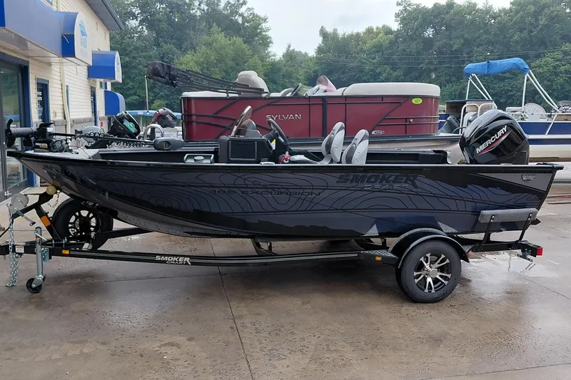 The Image of 2026 Smoker Craft Excursion 166 SC fishing boat on trailer, parked outdoors. - 0