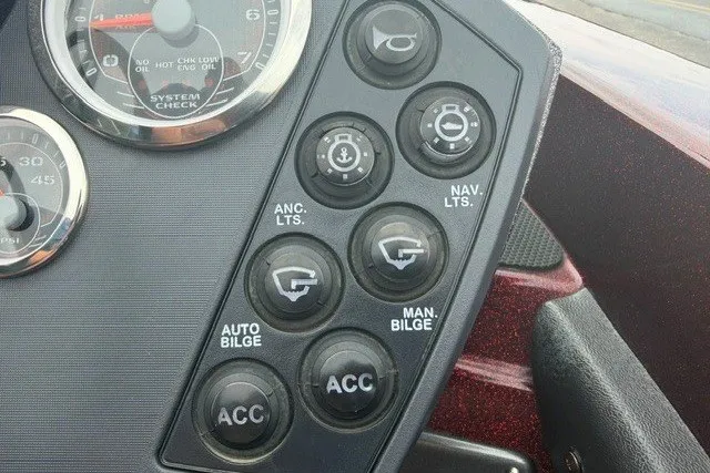 Slide: The Image of Control panel of a 2014 Ranger Z118 boat with various switches and gauges. - 9