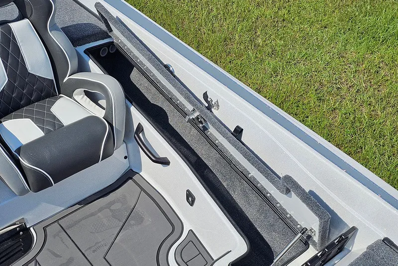 Slide: The Image of 2027 Phoenix 921 Elite X boat interior with sleek seating and storage compartment. - 22