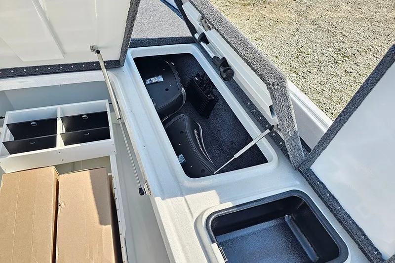 Slide: The Image of Open storage compartments in a 2027 Phoenix 921 Elite X boat, showcasing organized interior space. - 25