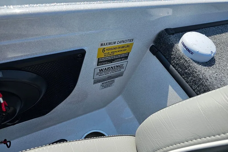 Slide: The Image of Interior of 2027 Phoenix 921 Elite X boat showing capacity and warning labels. - 16