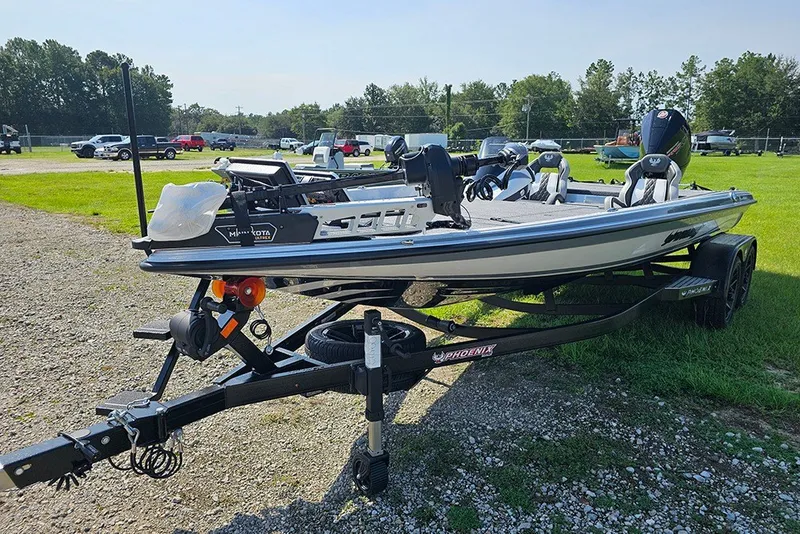 Slide: The Image of 2027 Phoenix 921 Elite X boat on trailer, parked on gravel near grassy area. - 5