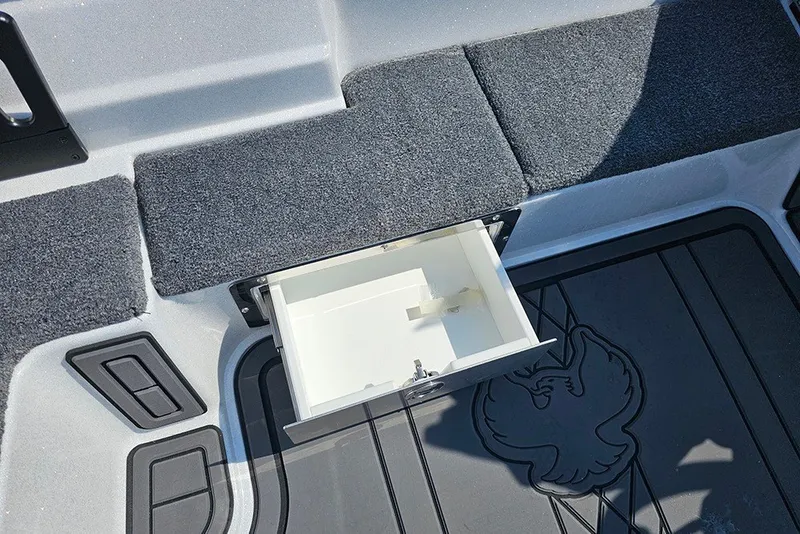 Slide: The Image of 2027 Phoenix 921 Elite X boat interior with open storage compartment and carpeted flooring. - 20