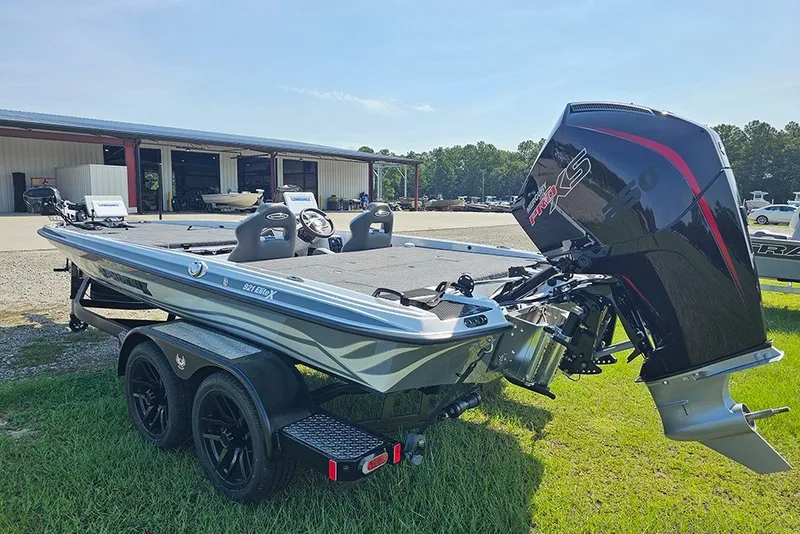 Slide: The Image of 2027 Phoenix 921 Elite X boat with powerful engine, parked outdoors on grass. - 7