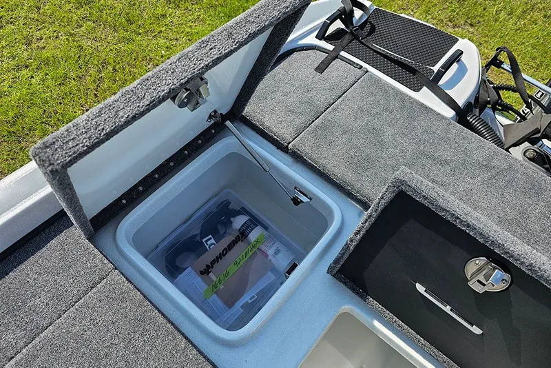 Slide: The Image of Open storage compartment in 2027 Phoenix 921 Elite X boat, showcasing organized interior. - 11