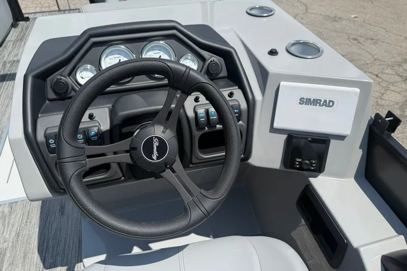 Slide: The Image of 2026 Bentley Pontoons Legacy 243 Navigator dashboard with steering wheel and Simrad display. - 5