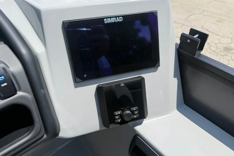 Slide: The Image of 2026 Bentley Pontoons Legacy 243 Navigator dashboard with Simrad and JBL controls. - 6