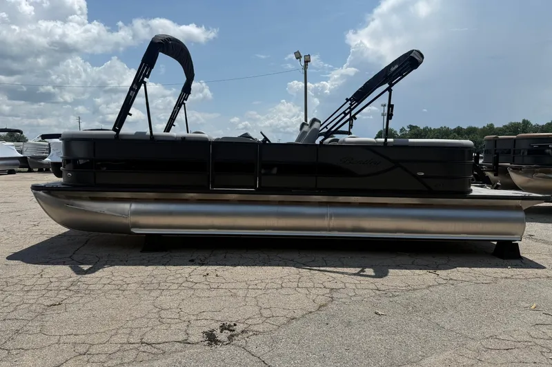 Slide: The Image of 2026 Bentley Pontoons Legacy 243 Navigator on a sunny day, showcasing sleek design. - 2