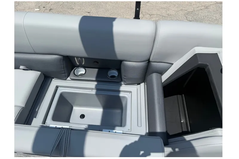 Slide: The Image of 2026 Bentley Pontoons Legacy 243 Navigator interior with storage compartment and cup holders. - 14