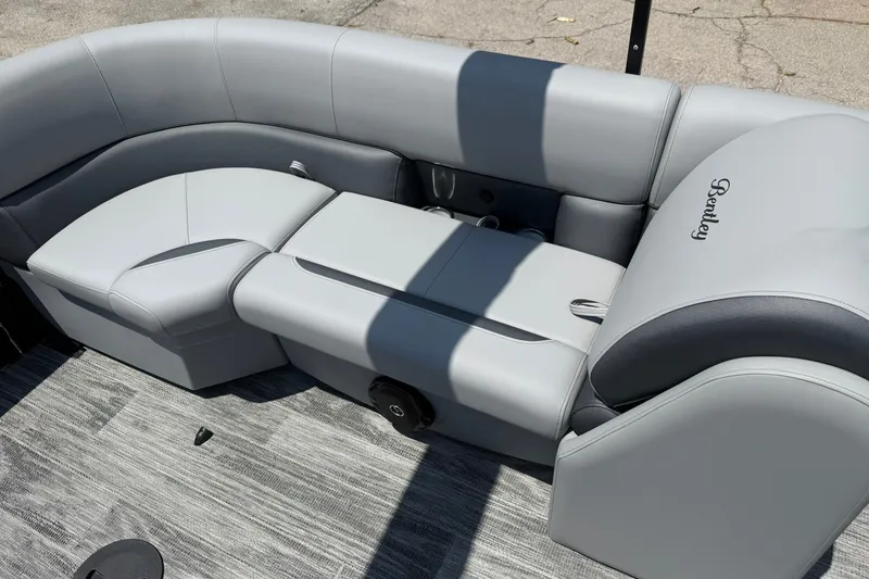 Slide: The Image of 2026 Bentley Pontoons Legacy 243 Navigator interior with luxurious gray seating and sleek design. - 13