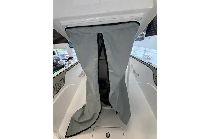 Slide: The Image of 2027 Wellcraft 202 Fisherman boat interior with gray zippered cover. - 21