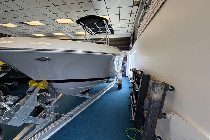 Slide: The Image of 2027 Wellcraft 202 Fisherman boat on trailer in showroom, side view. - 6