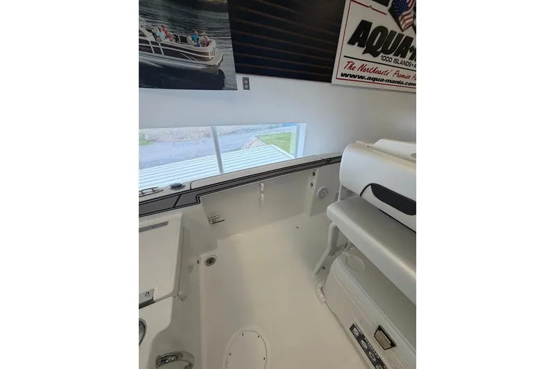 Slide: The Image of Interior view of 2027 Wellcraft 202 Fisherman boat, showcasing seating and storage area. - 19