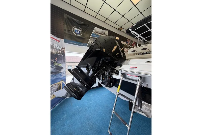 Slide: The Image of 2027 Wellcraft 202 Fisherman boat with powerful outboard motor in showroom display. - 7
