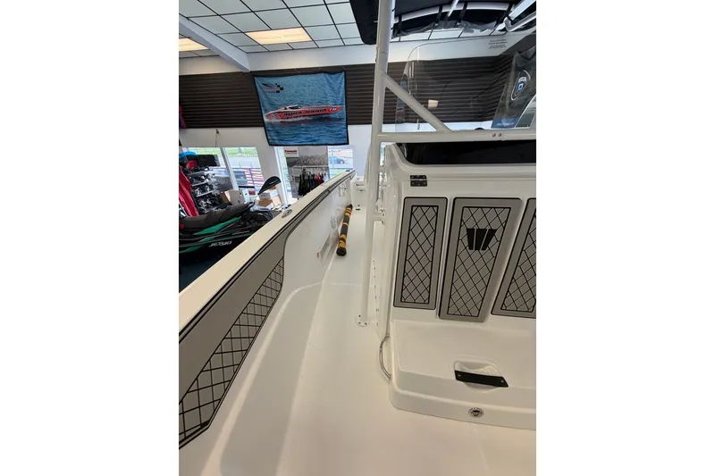 Slide: The Image of 2027 Wellcraft 202 Fisherman boat interior, showcasing storage compartments and sleek design. - 18