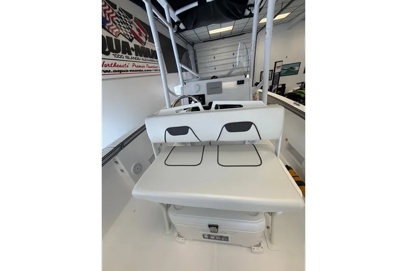 Slide: The Image of 2027 Wellcraft 202 Fisherman boat interior with seating and storage, displayed in showroom. - 8