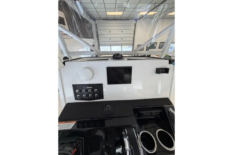 Slide: The Image of Control panel of 2027 Wellcraft 202 Fisherman boat with modern dashboard features. - 17