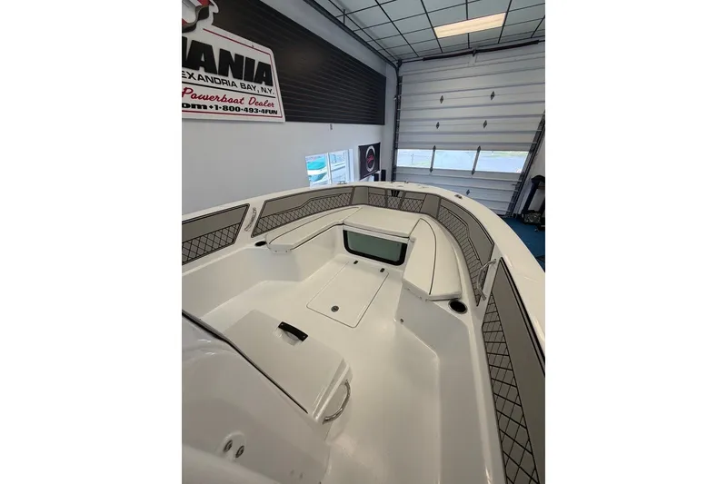 Slide: The Image of 2027 Wellcraft 202 Fisherman boat interior in showroom, featuring spacious seating and modern design. - 10
