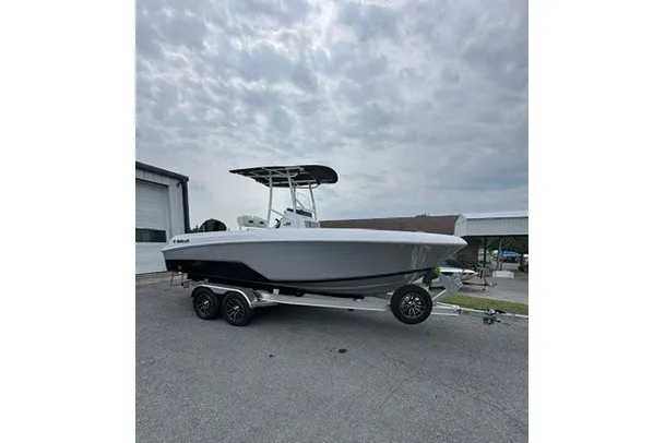 Slide: The Image of 2027 Wellcraft 202 Fisherman boat on trailer, parked outdoors under cloudy sky. - 1