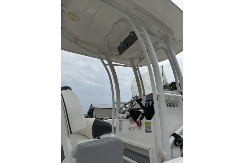 Slide: The Image of 2022 Robalo R222 Center Console boat interior with steering and seating. - 2