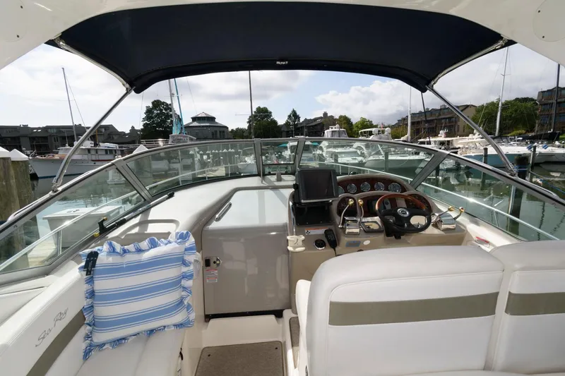 Slide: The Image of The cockpit of a 2006 Sea Ray Sundancer 320 with helm and seating area. - 4