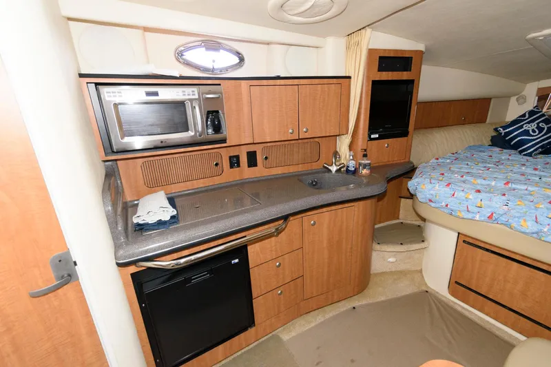 Slide: The Image of Interior of the 2006 Sea Ray Sundancer 320 with kitchenette and sleeping area. - 17