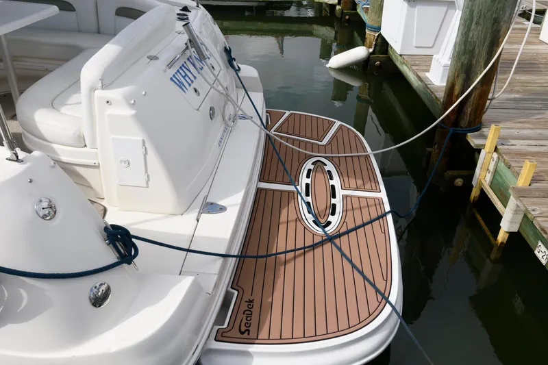 Slide: The Image of The image shows the stern of a 2006 Sea Ray Sundancer 320 with a teak-like platform. - 11