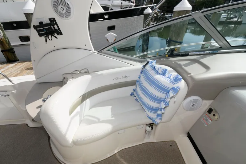 Slide: The Image of The image shows the cockpit of a 2006 Sea Ray Sundancer 320 with a cushioned seat and striped pillow. - 8
