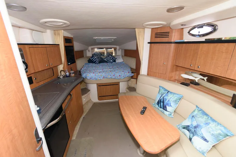Slide: The Image of Interior of the 2006 Sea Ray Sundancer 320 with cozy bed and seating area. - 14