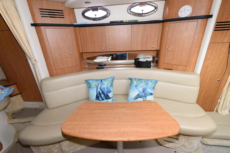 Slide: The Image of Interior of the 2006 Sea Ray Sundancer 320 with beige sofa and wooden table. - 15
