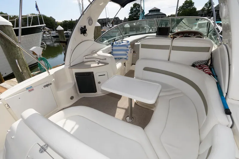 Slide: The Image of The image shows the cockpit of a 2006 Sea Ray Sundancer 320 with white upholstery. - 3