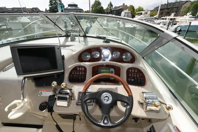 Slide: The Image of The image shows the cockpit of a 2006 Sea Ray Sundancer 320 with modern instruments. - 7