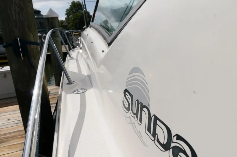 Slide: The Image of Close-up of a 2006 Sea Ray Sundancer 320's side, docked at a pier. - 12