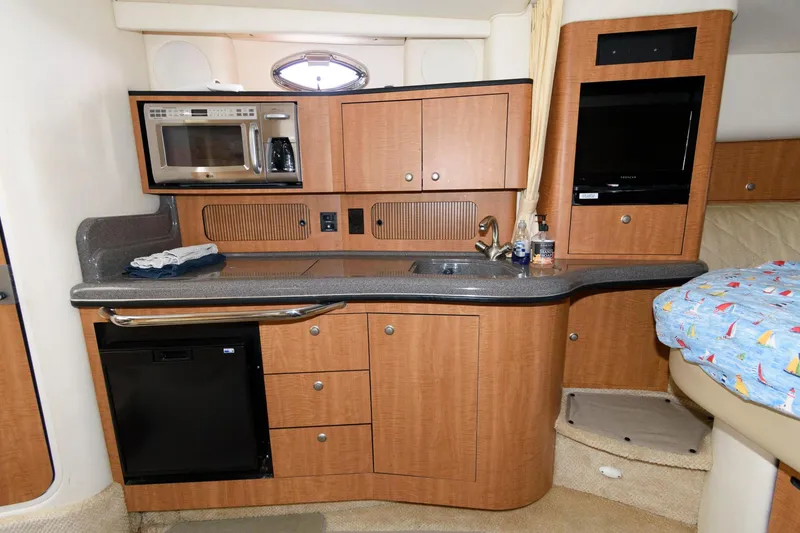 Slide: The Image of Galley of the 2006 Sea Ray Sundancer 320 with microwave, sink, and cabinets. - 16