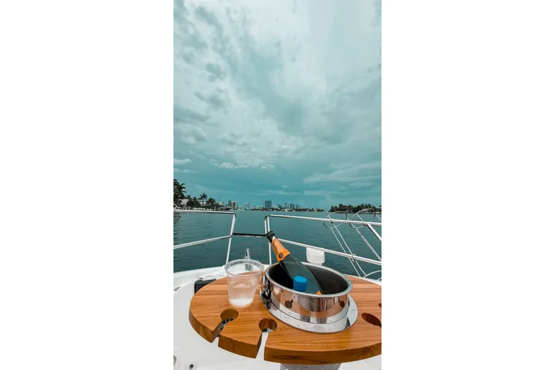 Slide: The Image of Luxury yacht Granfort 370 GTX 2026 with champagne bucket, ocean view, and city skyline. - 8