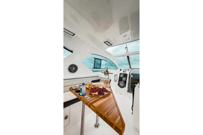 Slide: The Image of Interior of 2026 Granfort 370 GTX yacht with elegant wooden table and refreshments. - 9