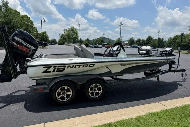 Slide: The Image of 2017 Nitro Z19 Pro boat with Mercury engine on a trailer in a parking lot. - 5