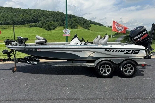 Slide: The Image of 2017 Nitro Z19 Pro fishing boat on trailer, parked outdoors with scenic green hills. - 4