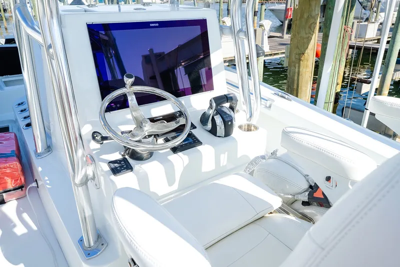 Slide: The Image of Helm of 2020 Costa Custom Boats 264HC with steering wheel and navigation display. - 24