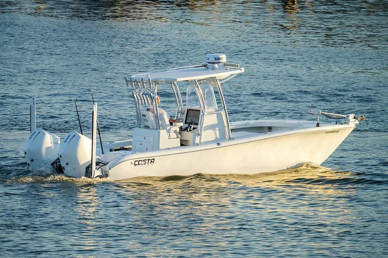 Slide: The Image of 2020 Costa Custom Boats 264HC cruising on water, showcasing sleek design and dual engines. - 13