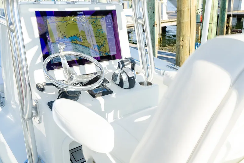 Slide: The Image of Helm of 2020 Costa Custom Boats 264HC with navigation display and controls. - 16