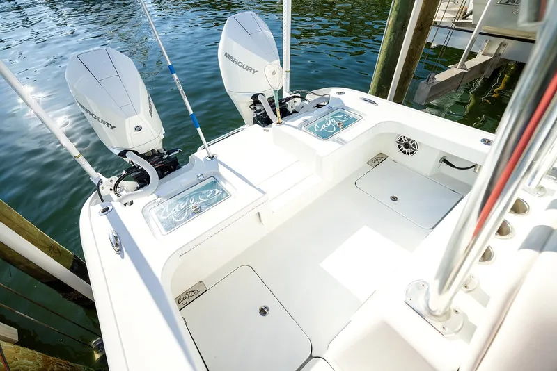 Slide: The Image of 2020 Costa Custom Boats 264HC with dual Mercury engines, docked on calm water. - 20