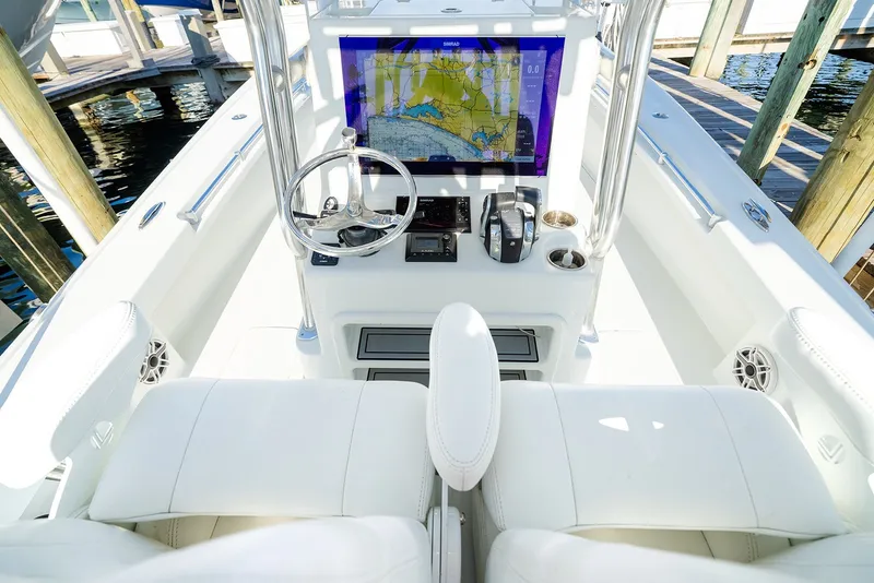 Slide: The Image of 2020 Costa Custom Boats 264HC helm with navigation display and white seating. - 17